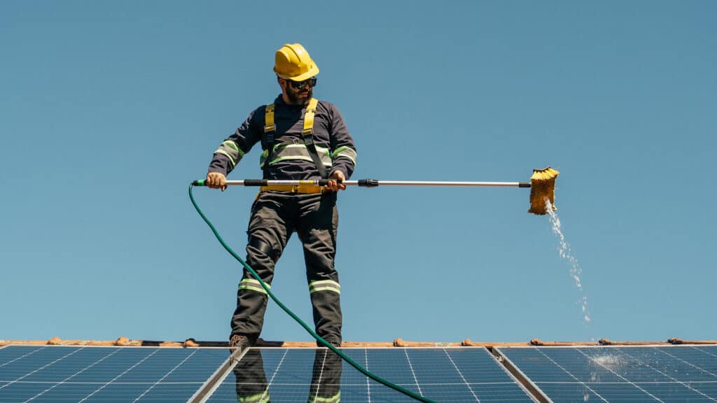 Solar Panel Maintenance in Colorado Springs Feature Image: Solar technician cleaning solar panels on rooftop